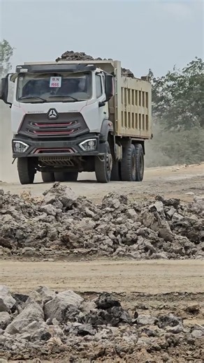 A 12-wheel Korean truck is transporting earth in Cambodia.