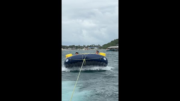 Inflatable UFO ride dumps beachgoers into the sea