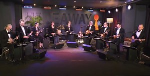 Watch a prim and proper cover of 500 Miles by The Ukulele Orchestra of Great Britain