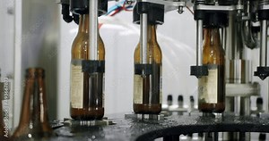 Beer bottles in production and bottling. Technological line. factory concept. Glass recycling process, recycled beer bottles on conveyor belt in factory. Brewery theme. conveyor belt at bottle factory