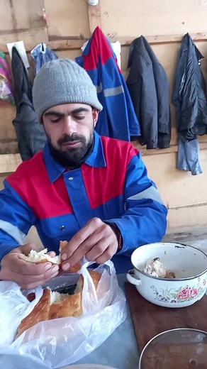 Enjoying Creamy Dip with Bread in Cozy Kitchen