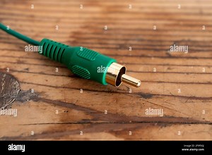 audio-video analog cable on an old wood table background Stock Photo - Alamy