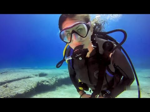 Female Diver is Diving with Neoprene Wetsuit