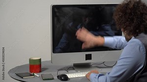 Businessman punches computer and keyboard that doesn't work - problems at work in office and smart working - hysterics against internet and modern technology, online addiction- virus and hackers