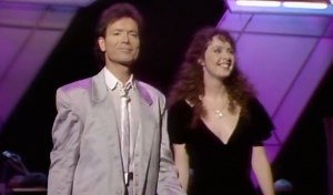 This week in 1986, Sarah released the beloved single “All I Ask of You” with Sir Cliff Richard. Taken from The Phantom of the Opera, this timeless duet captured hearts around the world and became a chart success, reaching the UK Top 3. ⭐️ That same year, Sarah and Cliff brought the song to life on the television programme Wogan, delivering a heartfelt performance that introduced the duet to millions of viewers at home. The moment has since become part of musical history, and was even revisited d