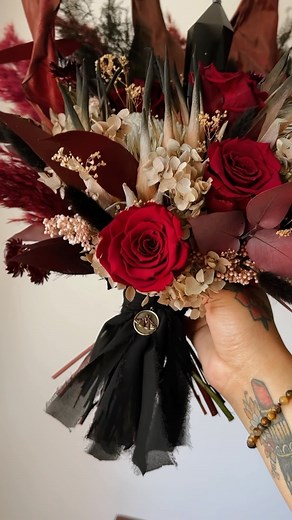 Which one would you choose? These gothic red and black wedding bouquets will be up for grabs during this Fridays restock at 9 AM PST ❤️‍🔥🖤🥀 First one is accompanied by a Black Obsidian Crystal Scepter. Second, a Black Rose Quartz Tower 🖤 #crystalbouquet #witchywedding #darkwedding #gothwedding #flowers #crystals #crystalwedding #burnablebouquet #weddingflowers #driedflowers #bridalbouquet #kirkland #alternativewedding #ronniefloweer #weepingwreath #gothflorist #gothflowers #witchyflowers #wi