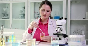 Urologist makes express analysis of urine using indicator paper closeup. General urinalysis and interpretation of results