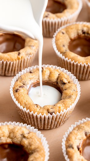 Ever wanted to dunk your milk IN your cookies instead of the other way around? 🤯 these Chocolate Chip Cookie Cups are crispy on the outside, chewy in the middle, and have a chocolate-lined center perfect for filling with milk (or ice cream...or whipped cream)! #cookiecups #chocolatechipcookies #brokenovenbaking | Broken Oven Baking Company