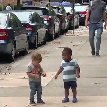 Two Toddlers Adorably Hug Each Other While Running on Street - 1067960