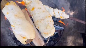 Making breakfast over the fire. Gator in a bannock blanket, eggs and smoked candied apples. | Jeff Barron