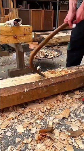 Shaving and shaping the large wooden logs into beautiful curved beams using traditional hand tools