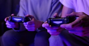 clip-1068043769-friends-playing-console-video-games-together-controller