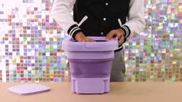 Person demonstrating how to use a compact, portable folding washing...