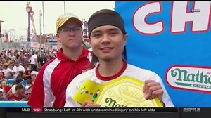 Hot dog eating champ edges out eight-year victor in annual contest