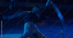 Close up of a young circus performer spinning in a massive wheel, gymnast, 4k