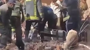 Rescuers attempting to remove rubble from building collapse in Assiut, Egypt