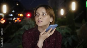 Woman makes short phone call by speakerphone, using telephone function conduct conversations through microphone and speaker or leaving voice message concept
