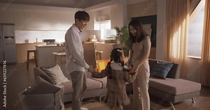 Portrait of a Happy Korean Family Arriving at Their Newly Purchased Home: Parents and Their Cute Daughter Excited for the New Beginning, Sharing a Milestone in Their Lives Together