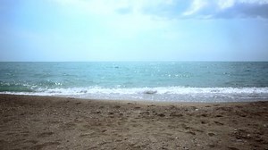 successful business woman in a business suit walking along the beach. concept - vacation. toned image.