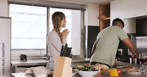 Food, couple and cooking in a kitchen by man and woman prepare salad, taste and embrace in their home together. Love, eating and interracial couple bond, relax and enjoy preparing healthy vegan meal