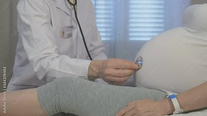 Doctor examines a young pregnant woman. Experienced physician checks the blood pressure of his patient. Monitoring of pregnancy and medical examinations during pregnancy.