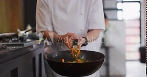 Caucasian female chef teaching diverse group preparing dishes and smiling