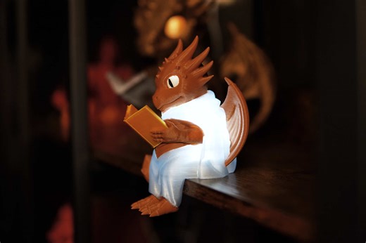 This is the Perched Dragon Reader, a robed little dragon who sits on the edge of your shelf or desk with a book in hand. I created two versions: a hollow version that sits over an LED tea light, and a solid version for those who prefer a standard print. The book prints separately which makes multicolor printing more simple. Happy printing! #dragons #booktok #bookstagram #3dprinting #bookdecor