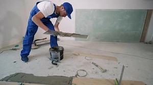 Construction, renovation, repair apartment. Installing ceramic floor tiles - measuring and cutting the pieces. Cuts tile. Tile cutting