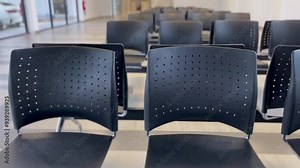 rows of airport chairs in a modern terminal, clean, sleek design of seating arrangements often seen in airports, providing a calm and organized environment, travel, transportation, airport design