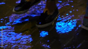 Feet walk through puddles on rainy day at outdoor, people enter a puddle