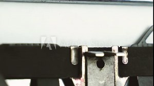 close up diagonal view typing text " follow us " on a old typewriter