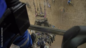 Crane moving Garbage in an Industrial Dumpster. Wast Recycling Plant. Operator Hand close up