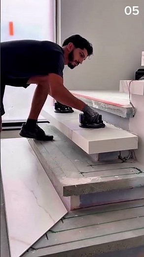 Stone slab lowered—suction grips guide each step’s precision