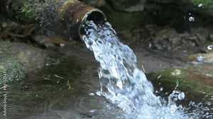 beautiful natural ecologic spring water streaming from tube. close up