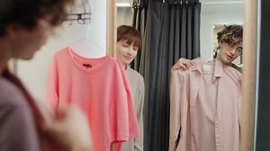 Female Assistant Helping Man with Choosing Clothes in Dressing Room