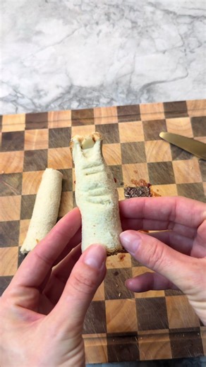 Creepy finger-shaped sandwiches with almond nail tips