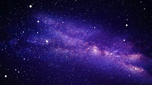 Camera flying through a purple celestial nebula constellation and star field in deep outer space.