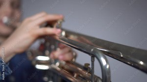 Young boy enjoying trumpet practice. Beloved musical instrument