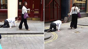 Woman walks man on a lead doggy style through Farringdon