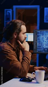 Software developer writes code on multimonitor setup PC to visualize artificial intelligence neural networks. Teleworking IT employee runs AI script on computer from home office, camera B