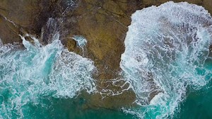 Top view of the desert beach on the Atlantic Ocean. Coast of the island of Tenerife. Aerial drone footage of sea waves reaching shore