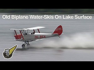 Tiger Moth biplane waterskiing on lake - like skimming stones