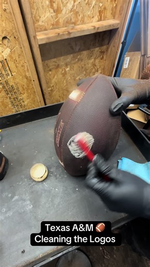 Cleaning the Logos on a Texas A&M Aggie Ball