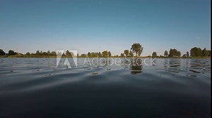 Young woman jumping from lake pier into blue water making lot of splashes and drops. Recreation, active living, embracing life, adventures