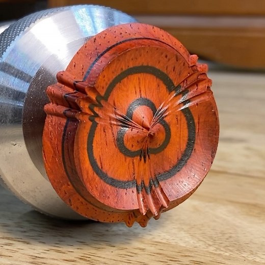 The conclusion of the Padauk Waltz. 3 lobe pattern with 3 spikes, cut into a biscuit made from 3 pieces alternating padauk, ebony, padauk. I think I’ll finish this as part of a lid for a small box. #roseengine #roseenginelathe #lathe #turning #ornamentalturning #complexturning #triple #waltz #padauk #ebony #pattern #geometry #art #workshop #sahamann | Spencer Hamann