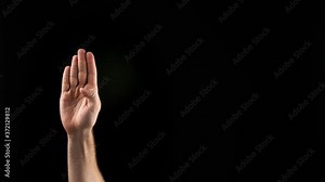 Hand showing letter B on dark background. Sign language alphabet