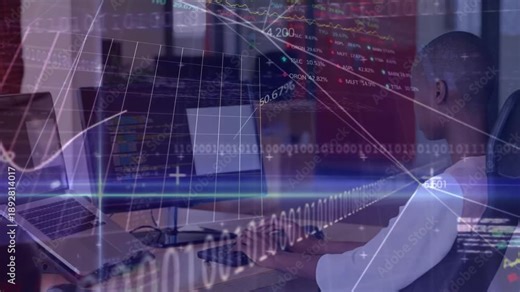 Man typing at workstation while overlay animations driving code and finance graphs for analysis