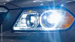 Sleek car headlight shines brightly, illuminating the dark. The design showcases automotive power and luxury. Perfect for showcasing innovative safety features