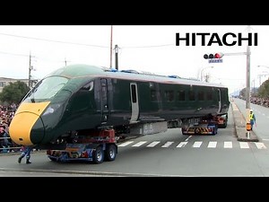 Observing a High-Speed Train Carried Through the City Streets - Hitachi