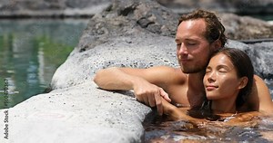 Romantic couple relaxing together in hot tub whirlpool jacuzzi luxury resort spa retreat. Luxurious hotel travel vacation.